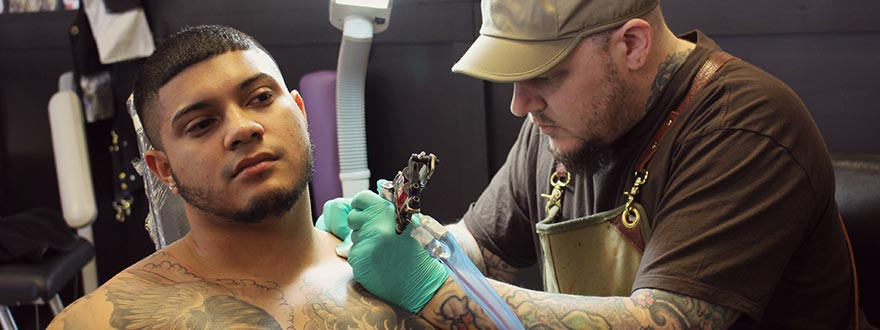 man being tattooed,vintage tattoo art